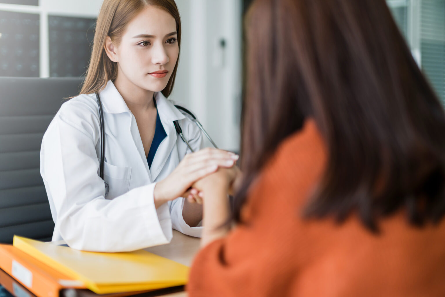 Asian woman doctor encouragement and supportive to cansor patien