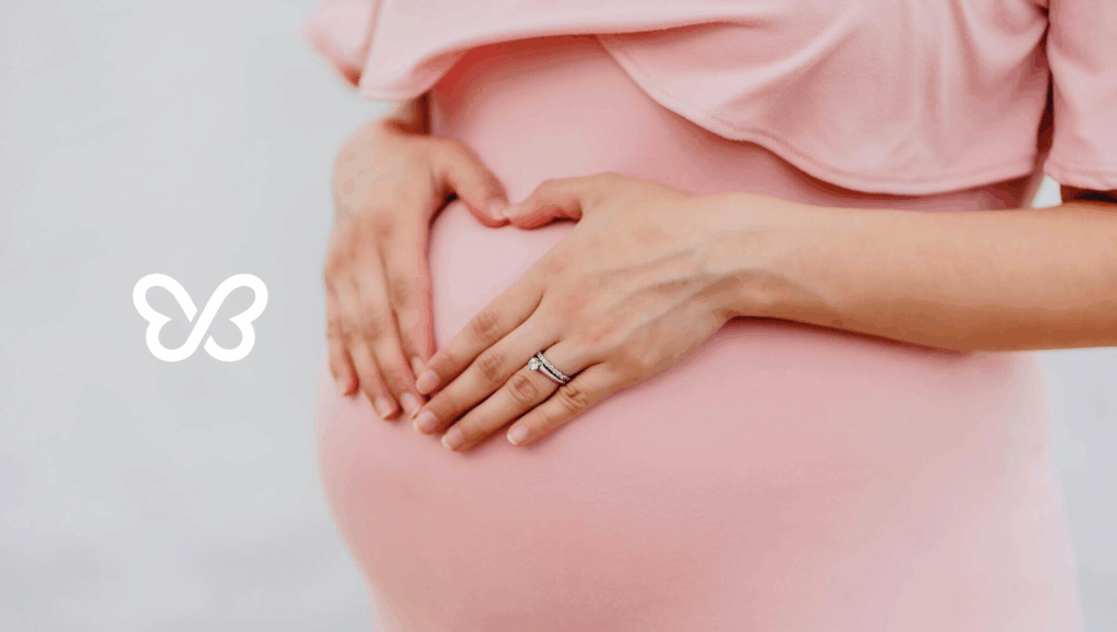 surrogate holding pregnant belly