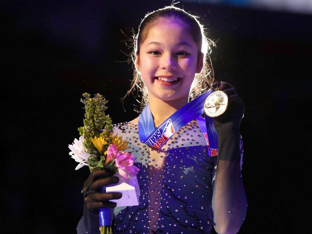 Oympic Champion Alysa Liu holding a medal